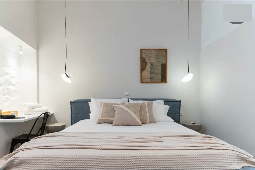 Bedroom neutral pillows pendant lights — Suite Aurelia at Syra di Giovanni 1862, Ermoupoli, Syros
