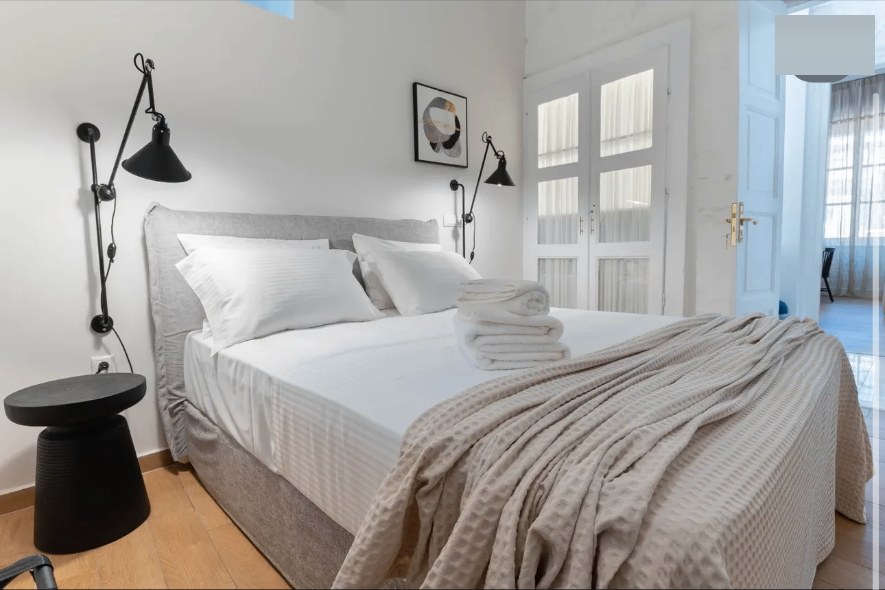 Bedroom wall sconces linen throw — Suite Aetheria at Syra di Giovanni 1862, Ermoupoli, Syros