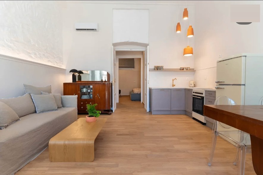 Aurelia open-plan kitchen with orange pendant lights above the dining table