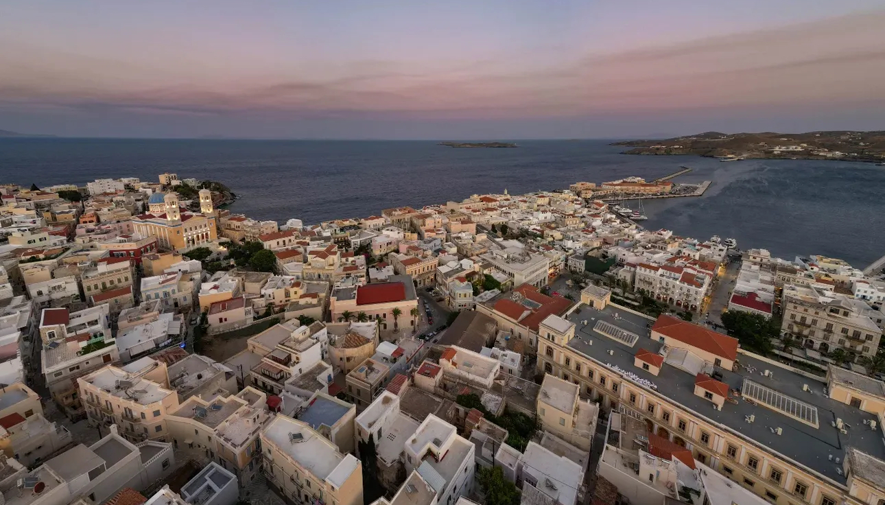 Aerial view of Ermoupoli at dusk with the blue dome of the Anastasi church, Syros